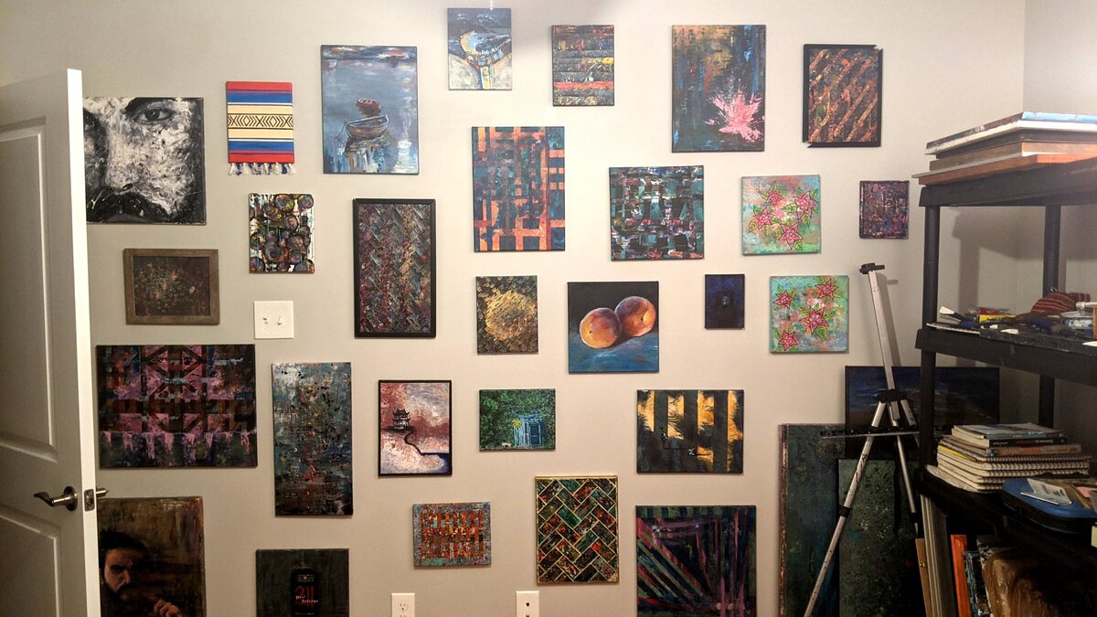 Kevin Guertler's studio wall showcasing various paintings