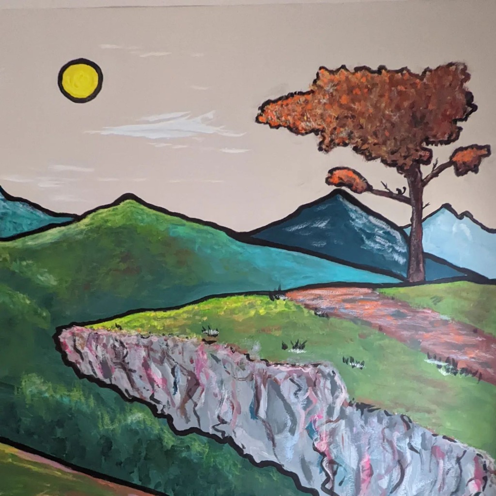 Mural of a cliff edge with mountains and a tree